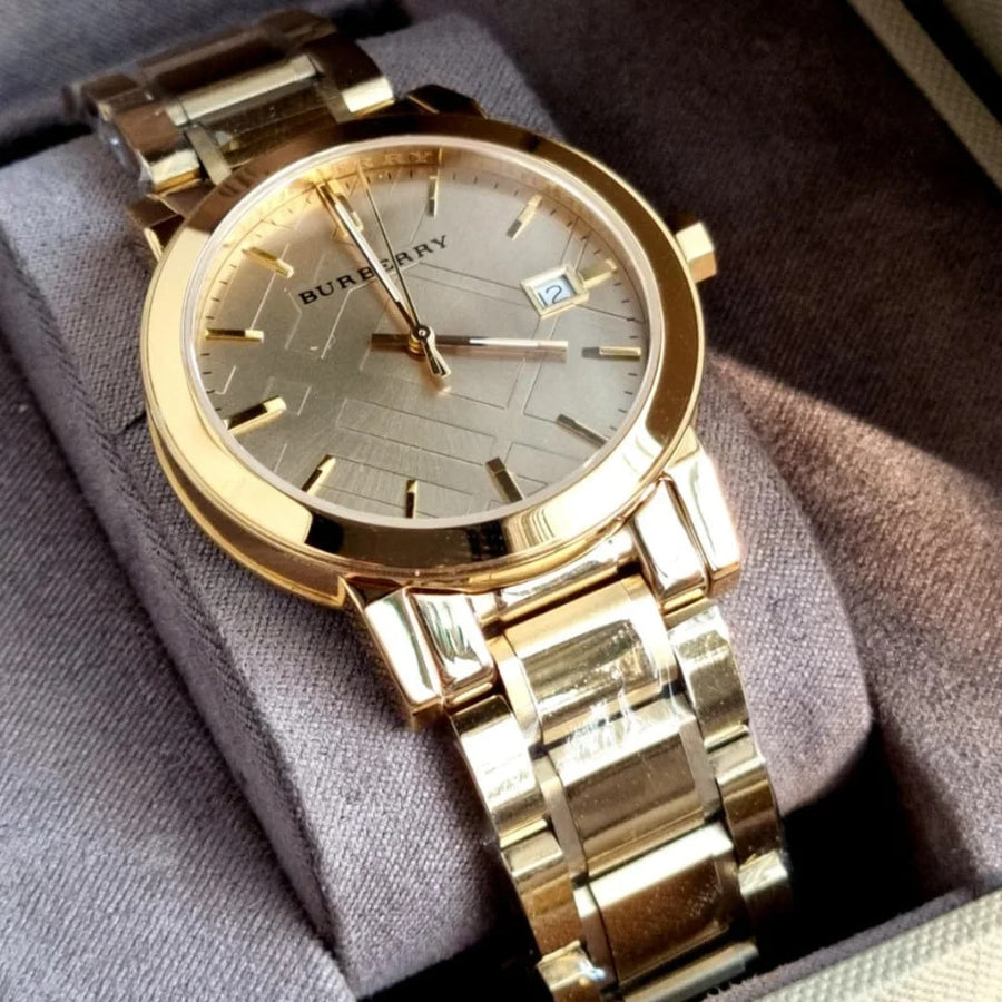 Front view of Burberry BU9033 unisex gold stainless steel watch with gold dial and minimalist design