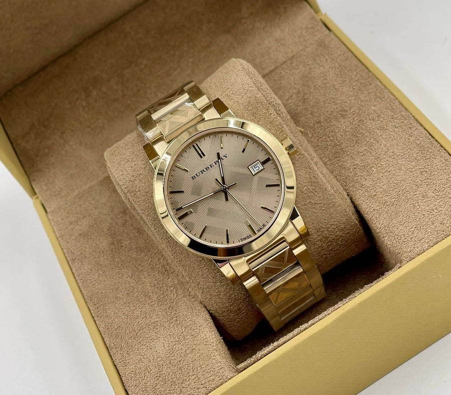 Front view of Burberry BU9038 unisex gold stainless steel watch with matching gold dial