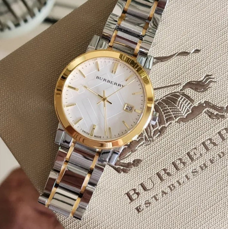 Close-up of Burberry BU9115 silver dial with gold-tone case and index markers