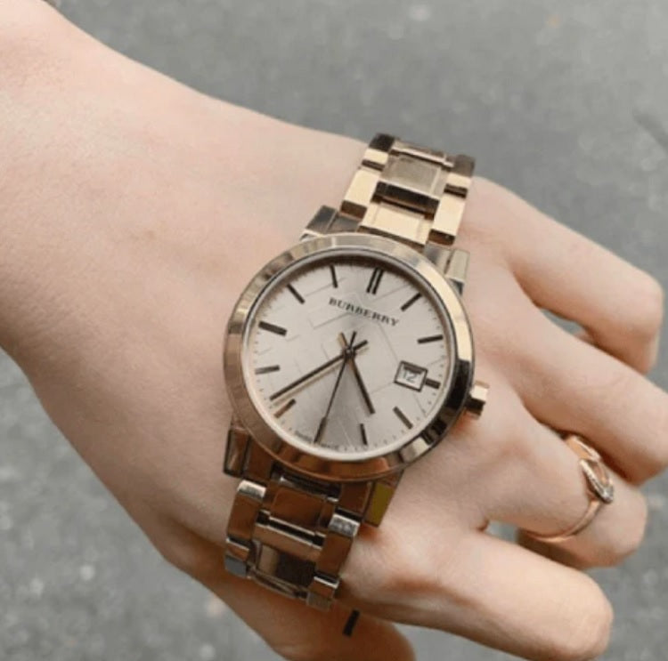 Front view of Burberry BU9134 women’s gold stainless steel watch with matching gold dial