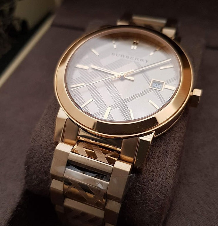 Front view of Burberry BU9038 unisex gold stainless steel watch with matching gold dial