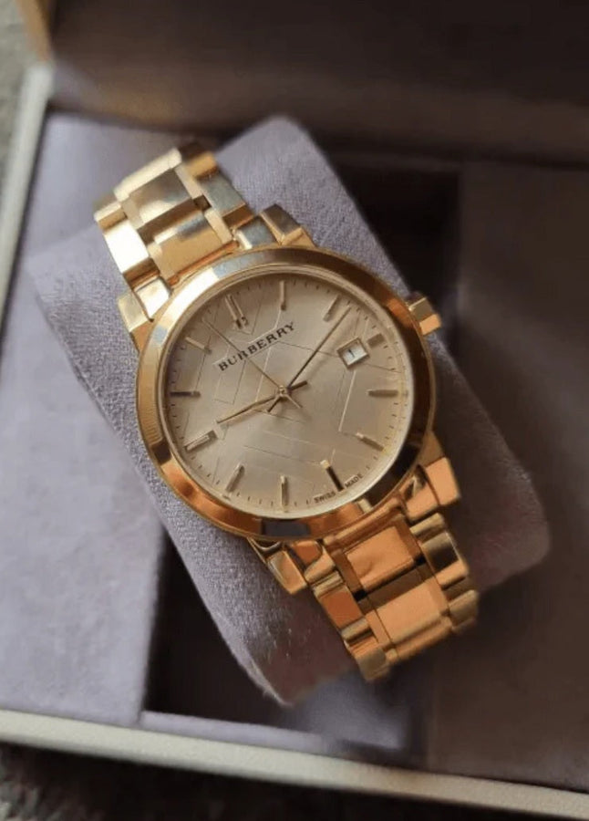 Front view of Burberry BU9134 women’s gold stainless steel watch with matching gold dial