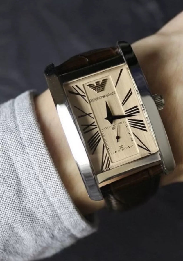 Front view of Emporio Armani AR0154 men’s watch with brown leather strap, beige dial, and silver case