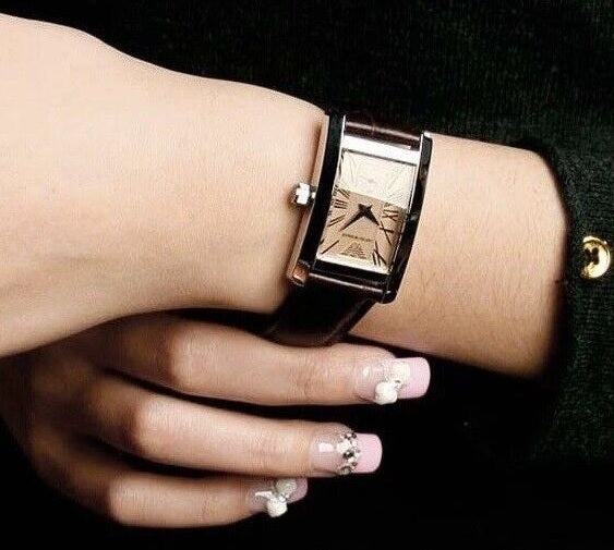 Front view of Emporio Armani AR0155 women’s watch with brown leather strap, beige dial, and silver case