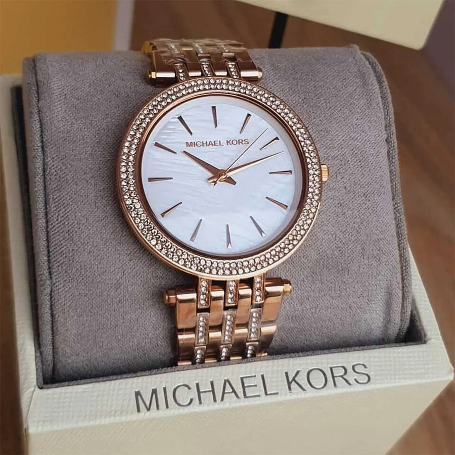 Close-up of Michael Kors MK3220 mother of pearl dial, featuring crystal accents and signature MK branding