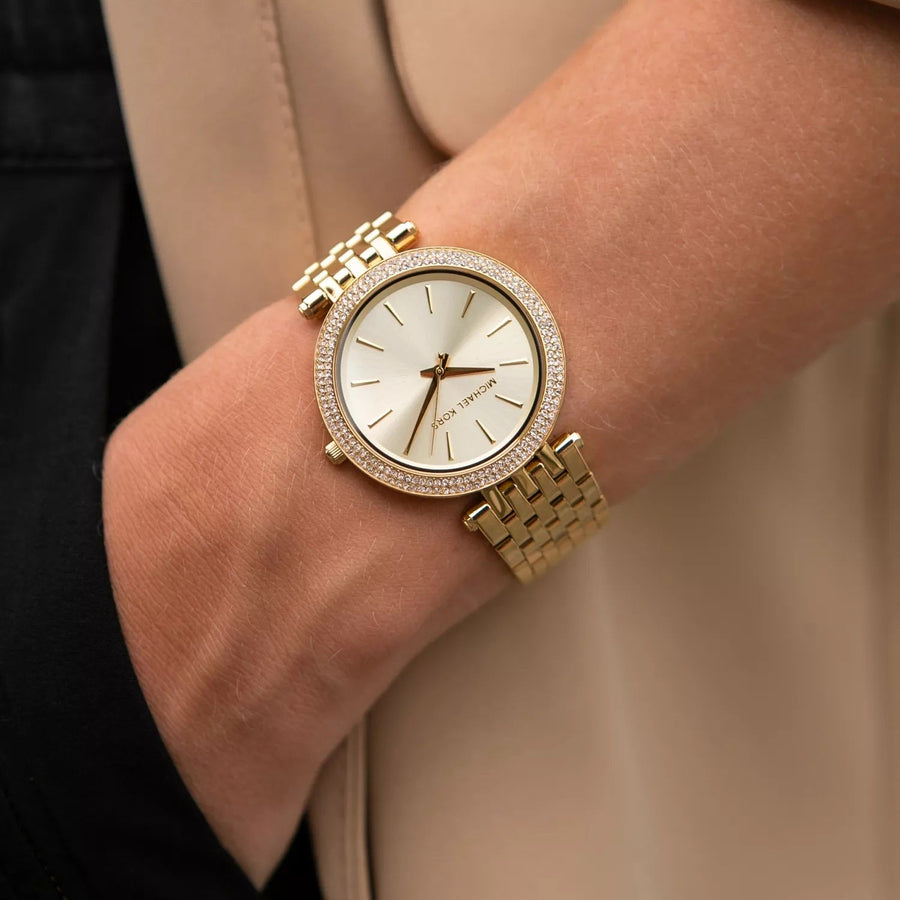 Front view of Michael Kors MK3191 women's watch with gold stainless steel strap, gold dial, and crystals