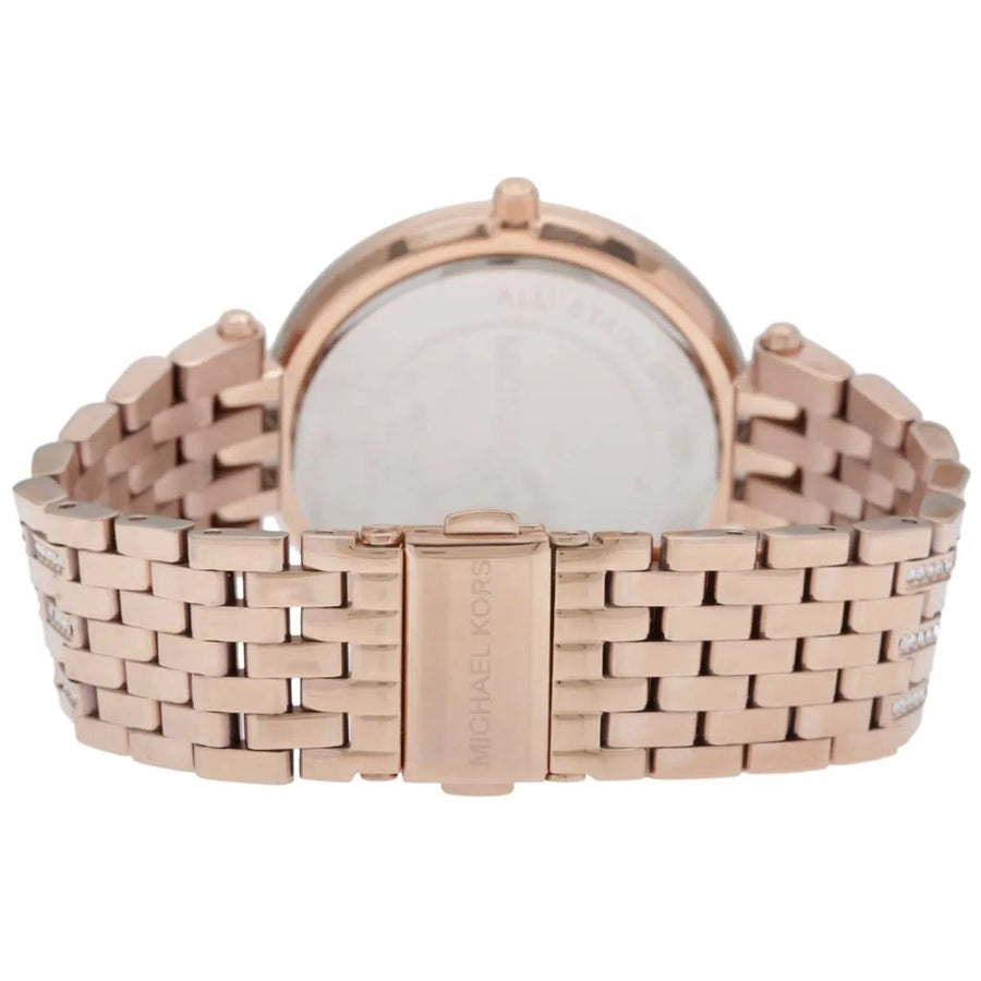 Close-up of Michael Kors MK3220 mother of pearl dial, featuring crystal accents and signature MK branding