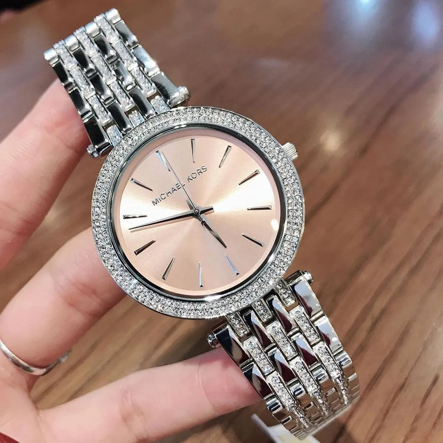 Front view of Michael Kors MK3218 women’s watch with stainless steel silver strap and beige dial, featuring crystals for added elegance
