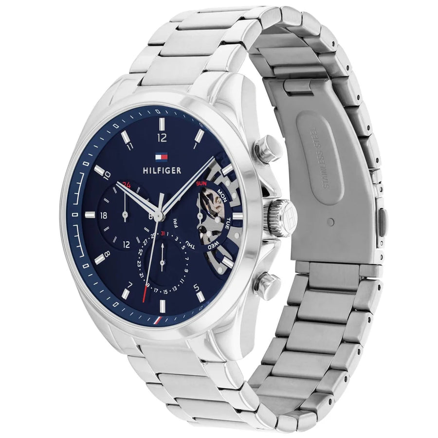 Tommy Hilfiger watch with blue dial and silver metal strap on a white background