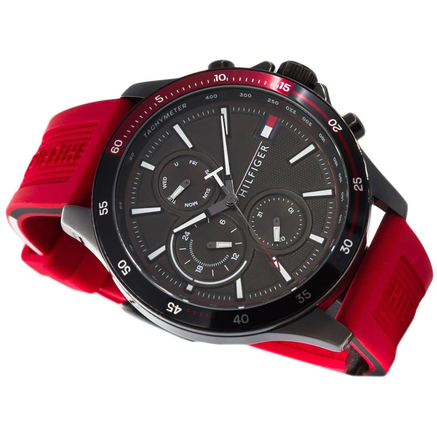 Close-up of Tommy Hilfiger 1791722 men’s watch featuring black dial, red silicone strap, and black case